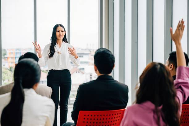 istock In a seminar classroom, a large group raises their hands to actively engage in the discussion. This audience is brimming with answers in a dynamic conference atmosphere. 2057154809