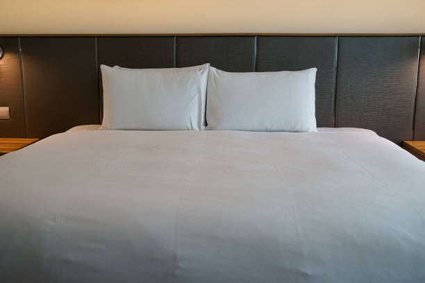 istock Bed with pillows, headboard in bedroom 2057169210