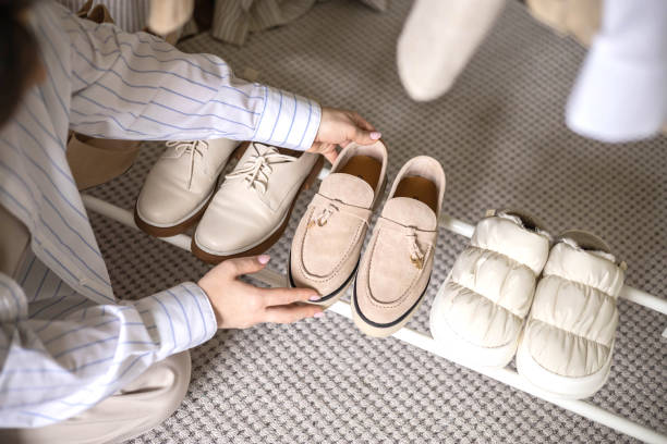 istock Modern woman choosing shoes putting on rack wardrobe comfortable storage organizing top view 2057184094