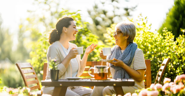 istock women drinking tea in the garden 2057205831