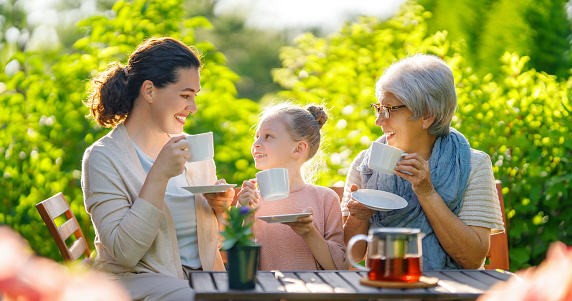 Smiling older lady wearing eyeglasses and using her phone