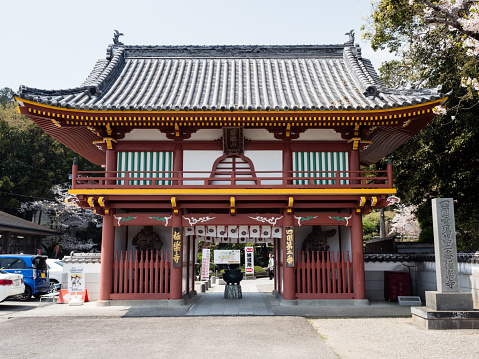 Naruto, Japan - April 2, 2018: Red entrance gate of Gokurakuji, temple 2 of Shikoku pilgrimage