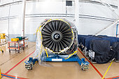 High-bypass turbofan aircraft engine in aviation hangar