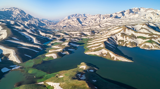 Legendary landscapes, meanders, lakes and snow texture in the transition from rare mountains to spring
