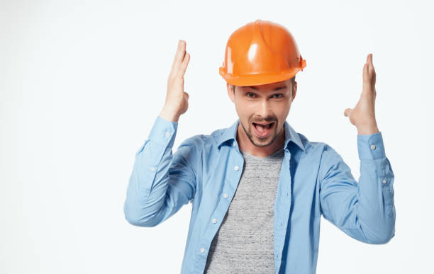 istock architect in orange helmet and unbuttoned shirt gesturing with hands cropped view white background 2057238829