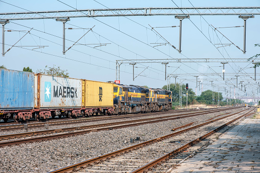 Pune, India - March 02 2024: Container freight train hauled by twin diesel WDG4 locomotives near Pune India.
