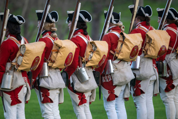 Huntington Beach CA USA - March 2, 2024: Reenactors portraying British soldiers line up in formation during the revolution war of the Philadelphia Campaign 1778 during the Huntington Beach Historical Society The Revolution, a reenactment of the American Revolution at Huntington Beach Central Park in Huntington Beach.