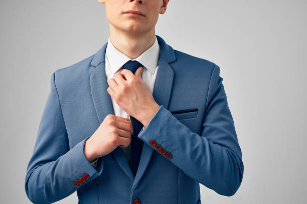 istock man in suit straightens his tie cropped view 2057251781