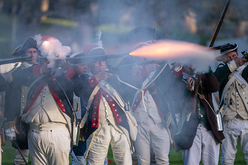Huntington Beach CA USA - March 2, 2024: Soldiers of the American Revolution \nfire their weapons during the The Huntington Beach Historical Society The Revolution, a reenactment of the American Revolution at Huntington Beach Central Park.