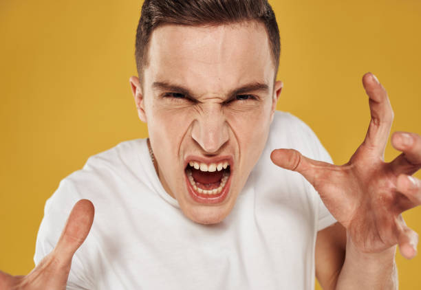 istock Aggressive man touches his head emotions model irritability 2057262968