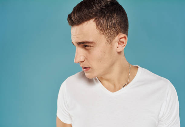 istock Man in white t-shirt studio close-up dissatisfaction 2057272156