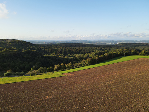 Aerial view of a countryside with farm fields and forest trees in summer
