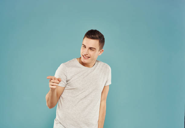 istock Man in white t-shirt Studio blue background emotions 2057294657
