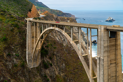 Bixby Bridge on a sunny day with the ocean behind it on the Central Coast of Big Sur, California