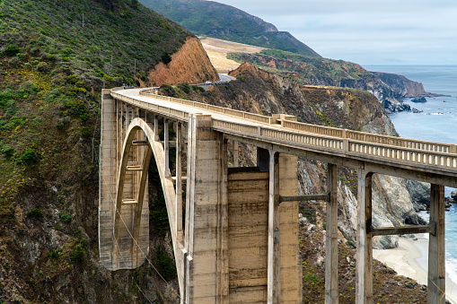 Angled Bixby Bridge on a sunny day with the ocean behind it on the Central Coast of Big Sur, California