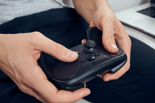 istock Gamepad male hands close-up video game addiction office technology 2057332674