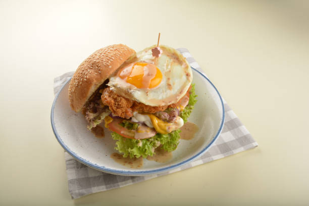 chef handmade giant deep fried crispy chicken with fried egg and vegetables cheesy burger in japanese sesame sauce restaurant western fast food cafe halal menu