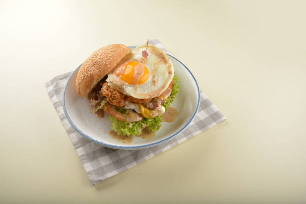 chef handmade giant deep fried crispy chicken with fried egg and vegetables cheesy burger in japanese sesame sauce restaurant western fast food cafe halal menu