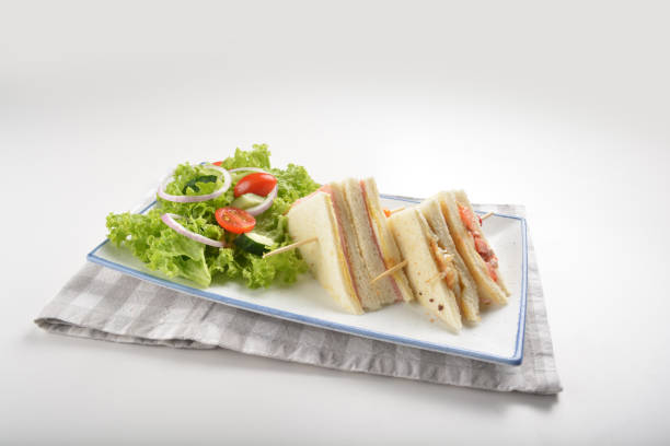 istock assorted sandwiches club with ham, cheese and mayo egg with salad in plate on white table restaurant western fast food cafe halal menu 2057341053