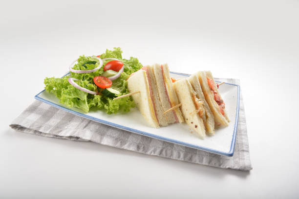 istock assorted sandwiches club with ham, cheese and mayo egg with salad in plate on white table restaurant western fast food cafe halal menu 2057341060