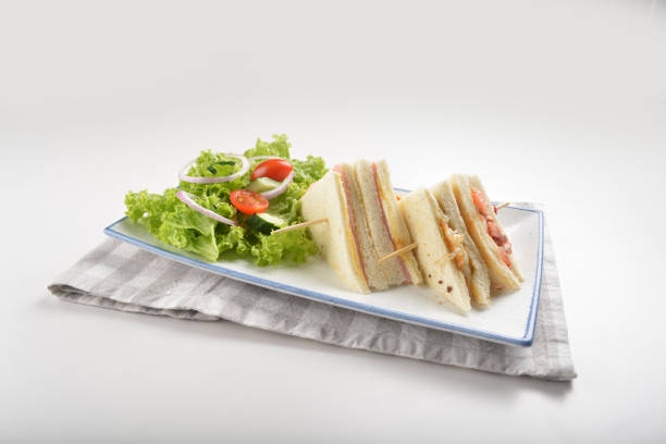 istock assorted sandwiches club with ham, cheese and mayo egg with salad in plate on white table restaurant western fast food cafe halal menu 2057341061