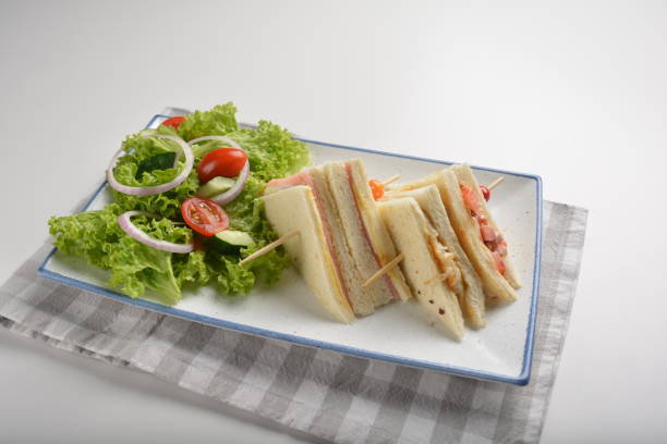 istock assorted sandwiches club with ham, cheese and mayo egg with salad in plate on white table restaurant western fast food cafe halal menu 2057341596