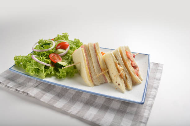 istock assorted sandwiches club with ham, cheese and mayo egg with salad in plate on white table restaurant western fast food cafe halal menu 2057341597