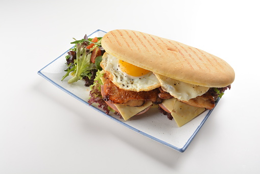 assorted sandwiches club with focaccia bread, grilled teriyaki chicken , cheese and fried egg with salad in plate on white table restaurant western fast food cafe halal menu