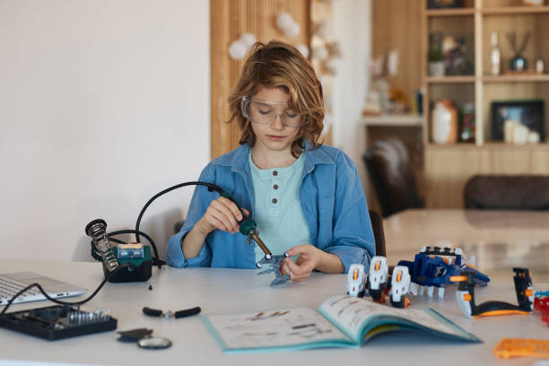 istock School boy working on his robot at home 2057360262