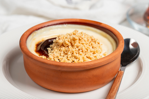 Rice pudding. Milky dessert. Oven-baked rice pudding dessert in a clay bowl. Close up