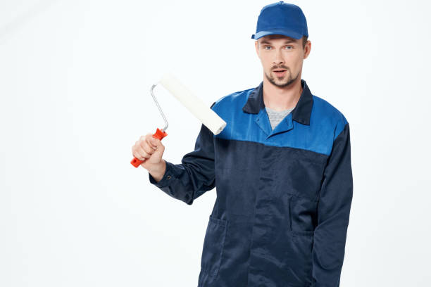 istock man in working uniform home repair painting service 2057369252