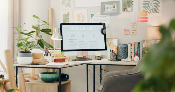 istock Empty, workspace and a computer in a home office for remote work, business or design of desk. Working, creative and a table with a pc and setup for a freelance career or entrepreneurship from a house 2057379913