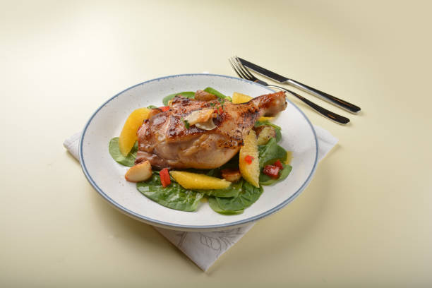 Tasty roast chicken in cooking pan on wooden desk