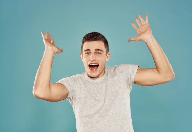Handsome man in white t-shirt studio lifestyle blue background. High quality photo