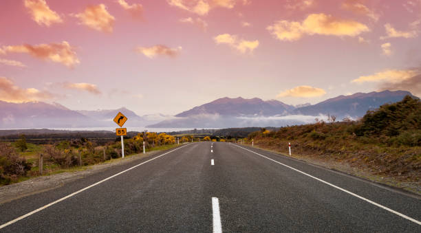 the road trip view of  travel with mountain view of autumn scene and  foggy in the morning with sunrise sky scene at fiordland national park - sunrise new zealand mountain range mountain - fotografias e filmes do acervo