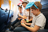 Three kids travelling by plane for Easter