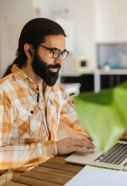 istock Happy tele operator attending call working with a laptop and headset at office 2057414368