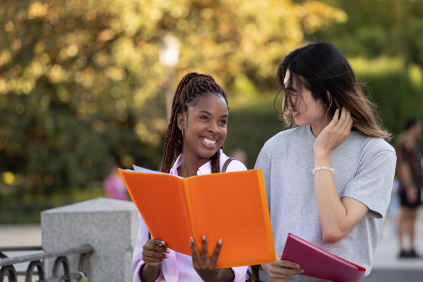 istock Happy multicultural students studying and learning walking outdoors 2057419102