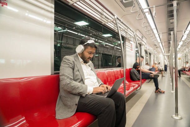 istock Businessmen typing on laptop while sitting at the Public Transportation 2057419662