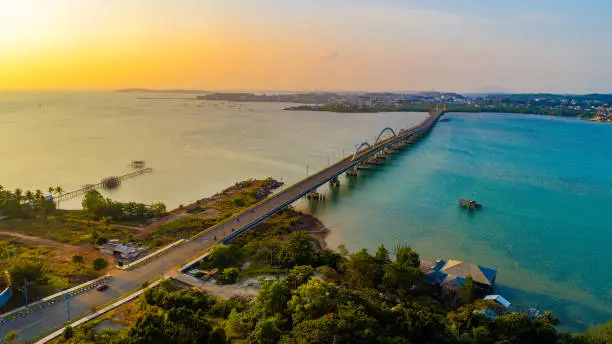 Photo of beautiful sunset over tanjungpinang city with dompak bridge