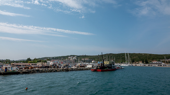 Sigacik, Izmir, Turkey Sept. 10,2023  Moored fishing boats at the Teos port marina with luxury yachts  in Sigacik, Izmir, Turkey.