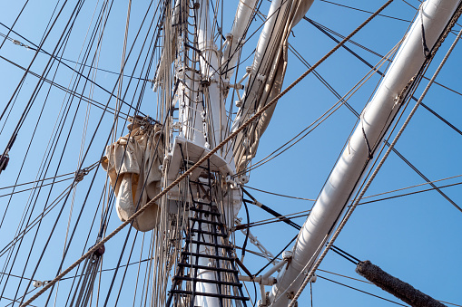 Tall ship mast in sunshine, low angle view, background with copy space, full frame horizontal composition