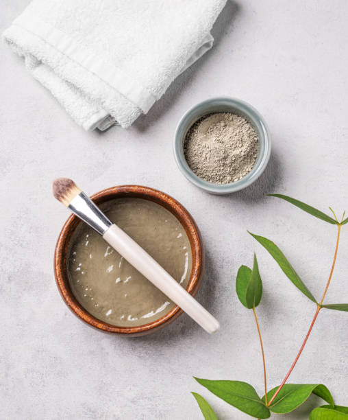istock Blue clay with brush on a light background with towel and branch. 2057453179