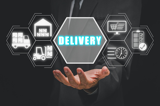 Delivery concept, Businessman hand holding delivery icon on virtual screen.