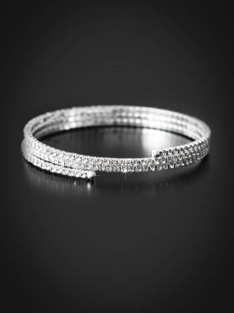 istock Silver bracelet isolated on black background 2057466359