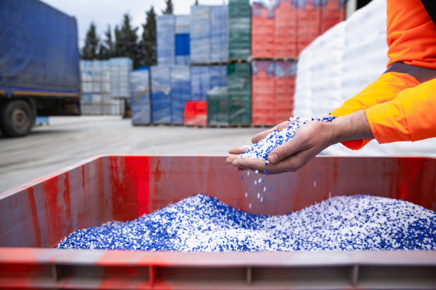 istock Plastic granules are poured from the hand. 2057471659