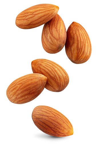 Almond isolated. Almonds flying on white background. Perfect retouched almond nuts side view. Full depth of field.