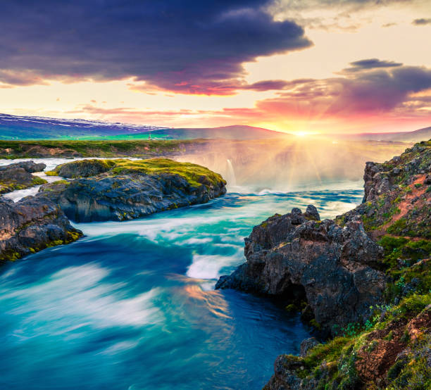 Picturesque summer morning scene on the Godafoss Waterfall. Colorful sunrise on the on Skjalfandafljot river, Iceland, Europe. Artistic style post processed photo.