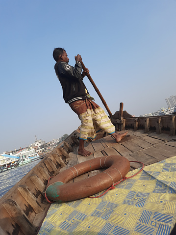 Sadarghat river view landscape, Transporting local people by small boats across the river, Commuter ferryboat in the monsoon, Boat ride in the Buriganga river.