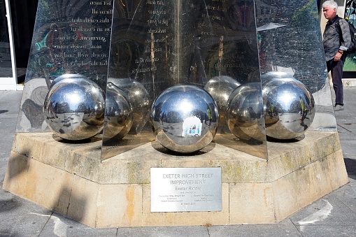 Silver balls at the base of the Exeter Riddle sculpture along High Street in the city centre, Exeter, Devon, UK, Europe.